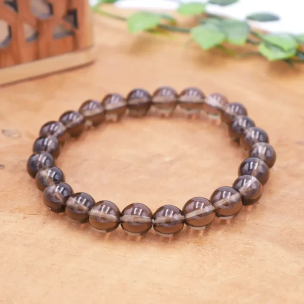 Bracelet en Quartz Fumé naturel de qualité premium, perles translucides en pierre fine et montage élastique artisanal haute résistance.