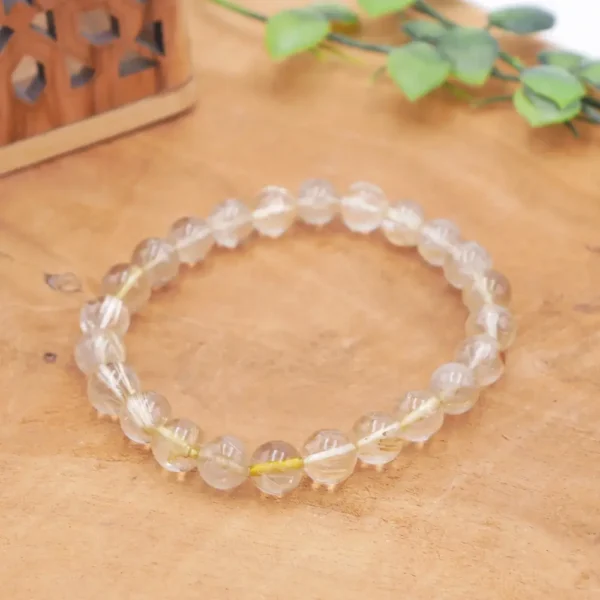 Bracelet en Quartz Rutile naturel, perles de cristal transparent avec inclusions d'aiguilles de rutile doré (cheveux de Vénus) sur fil résistant.