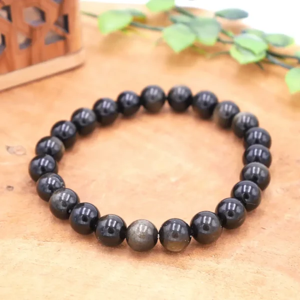 Bracelet en Obsidienne dorée naturelle, perles noires aux reflets pailletés or qui se révèlent à la lumière, montage artisanal robuste.