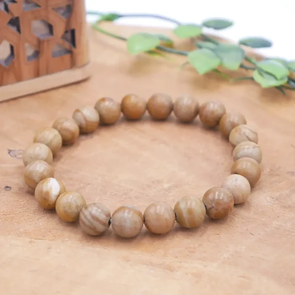 Bracelet en Jaspe Bois naturel, perles aux motifs veinés marron et beige rappelant l'écorce, montées sur fil élastique haute résistance.