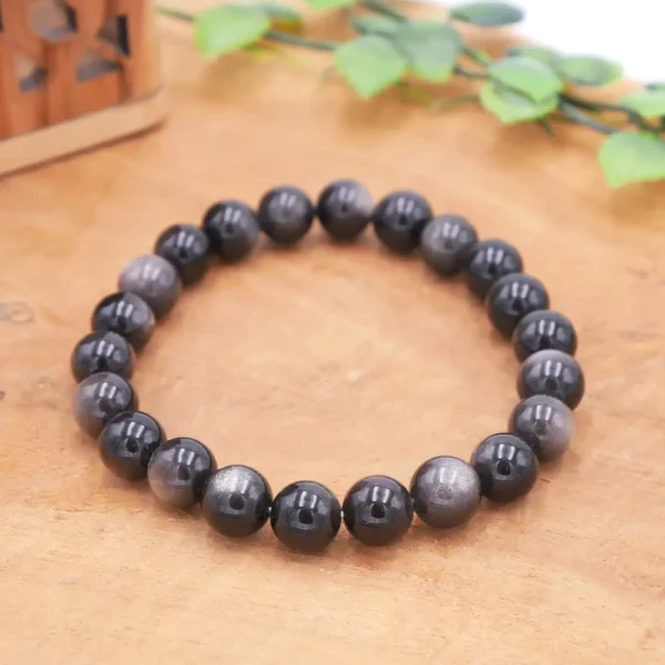 Bracelet en Obsidienne argentée naturelle, perles noires aux reflets pailletés argent qui se révèlent à la lumière, montage artisanal robuste.